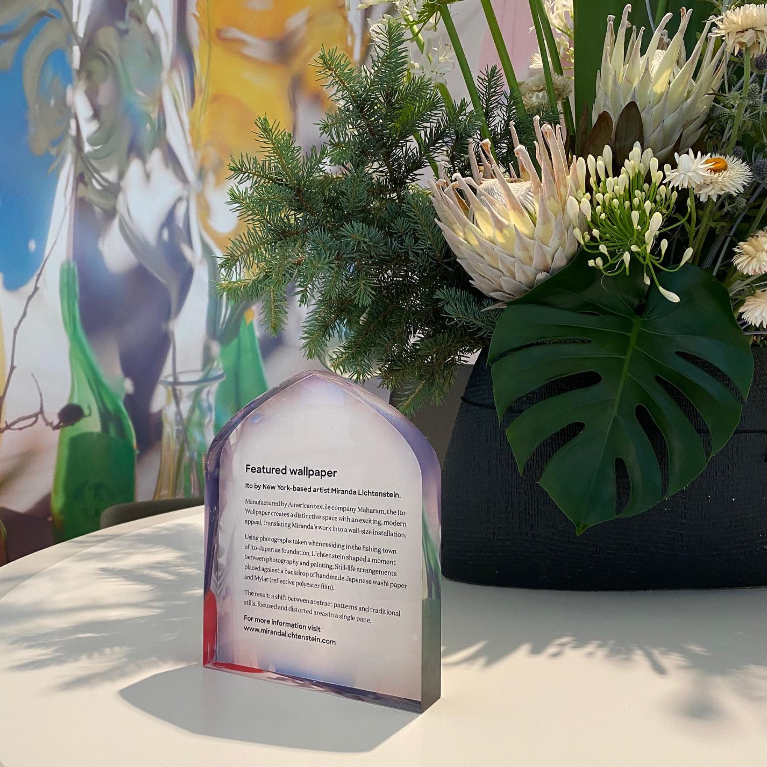 Artist Bio Plaque sitting on the front desk in the lobby of 550 Bourke St