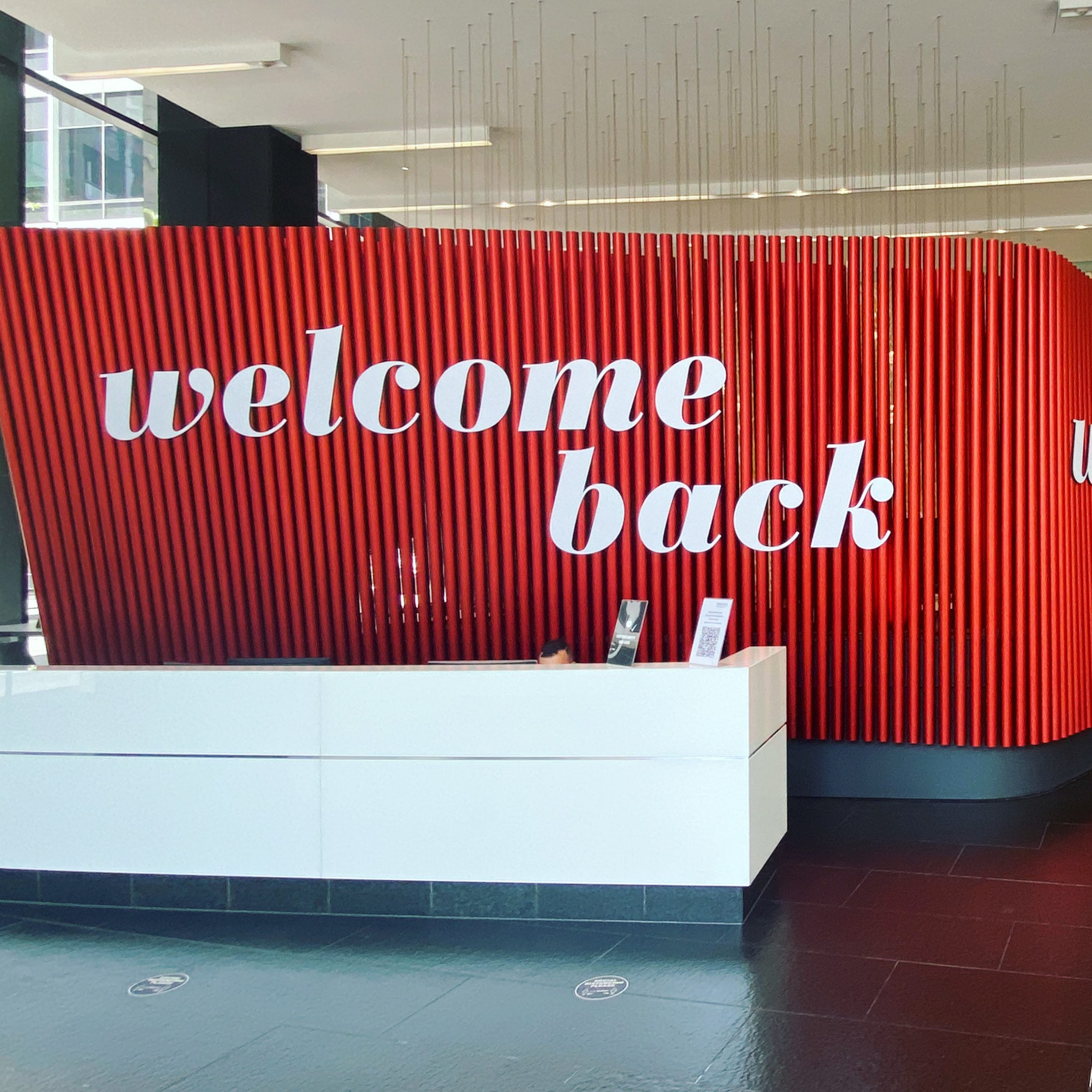 Welcome Back sign applied to wall of lobby at 2 Southbank Boulevard