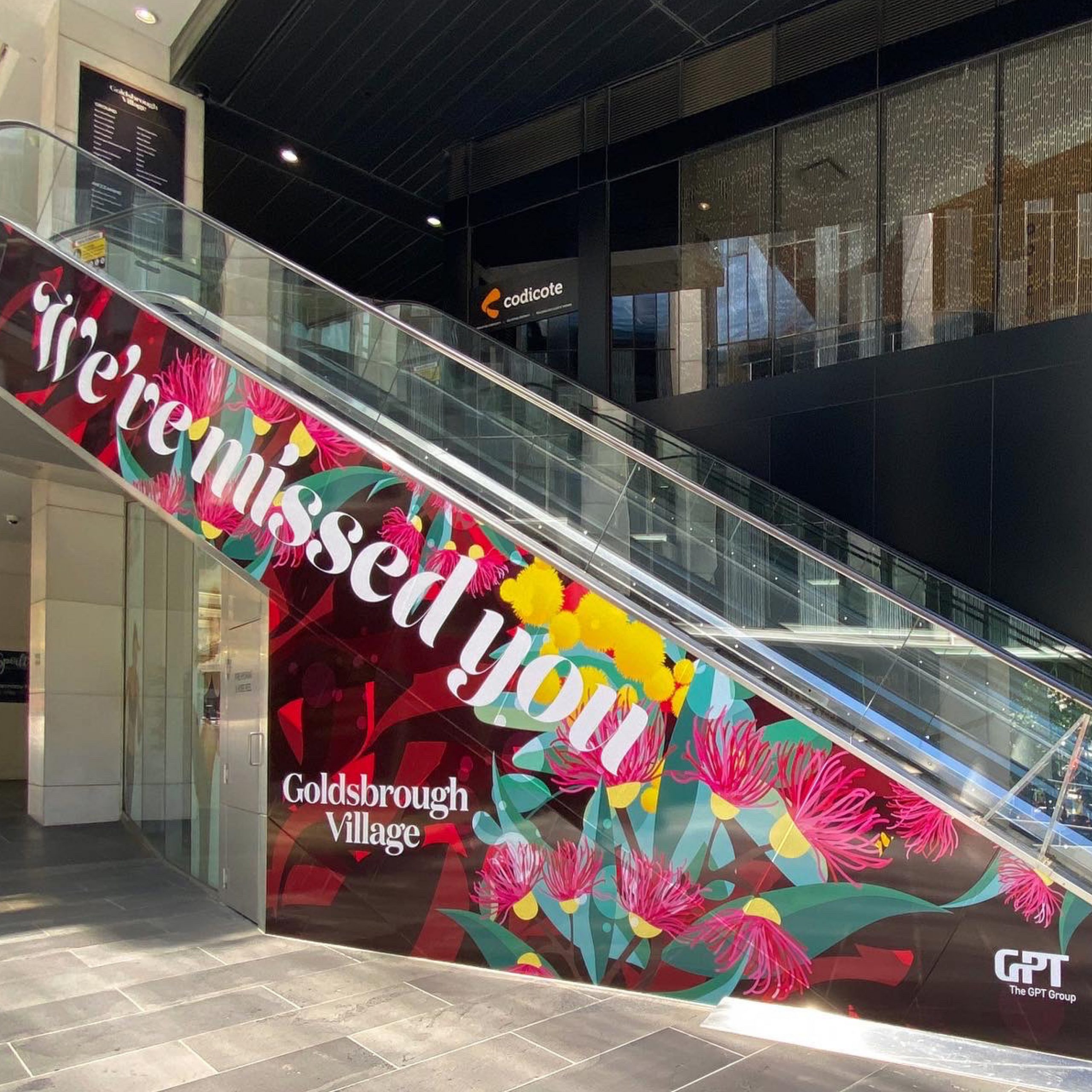 Welcome Back vinyl decal applied to side of escalator at Goldsbrough Village, CBW